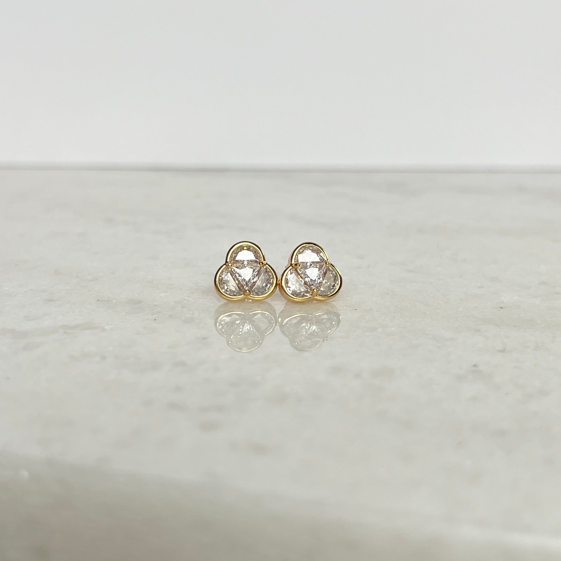 Three in one shaped triangular gold and cubic zirconia stud earrings, representing the Most Holy Trinity. 